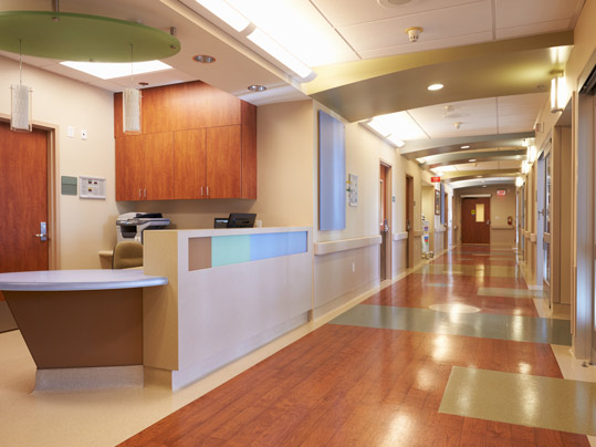 Empty Nurses Station And Corridor In Modern Hospital.